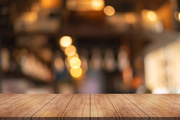 istock Empty wooden table top with lights bokeh on blur restaurant background. 1757552044