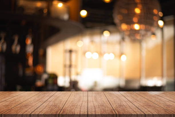 istock Empty wooden table top with lights bokeh on blur restaurant background. 1757552338