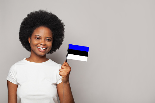 Estonian woman holding flag of Estonia Education, business, citizenship and patriotism concept