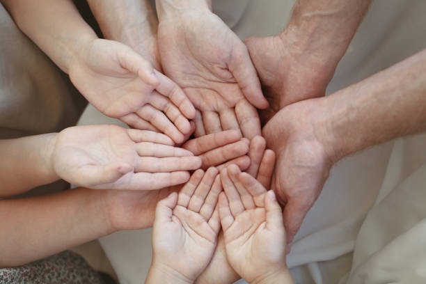 istock Human hands, many people holding empty space on hand together 1757564227