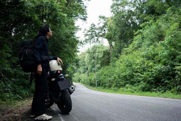 istock people activity concept with asian man biker take picture in tropical forest with his motorcycle 1757575175