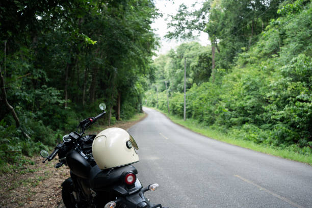 istock people activity concept with biker take picture in tropical forest with his motorcycle 1757577479