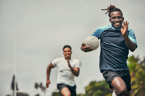 Rugby, energy and black man with ball running to score goal on field at game, match or practice workout. Sports, fitness and motion, player in action and blur on grass with energy and skill in sport.