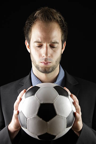istock business man with soccerball (low-key studio shot) 175759037