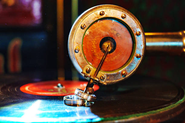 istock Wedding rings on gramophone needle and record. 1757594535
