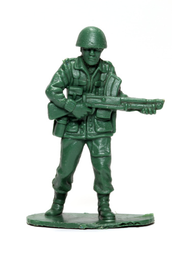 A green toy soldier against a white background.