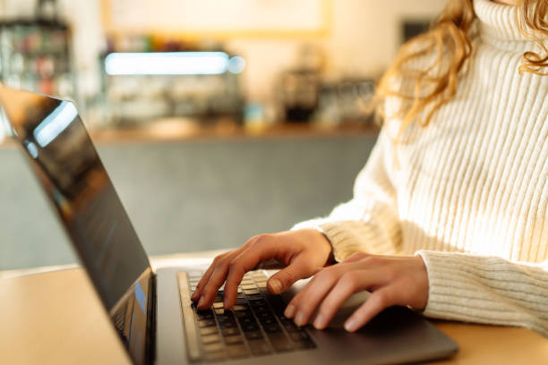 istock Woman works on a laptop in a cafe. 1757619239