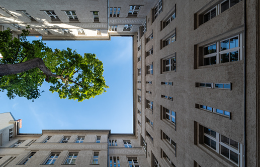 Germany, Berlin, October 02, 2023 -Low angle view of residential building against sky and tree, Berlin Schöneberg
