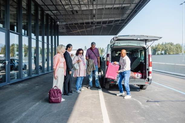 istock Mature Latin-American Van Driver Carrying A Passenger Suitcase 1757621438