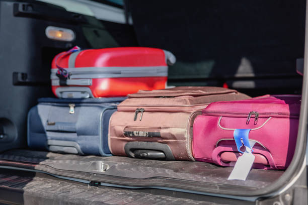 istock Car Trunk Loaded With Different Color Suitcases 1757621952
