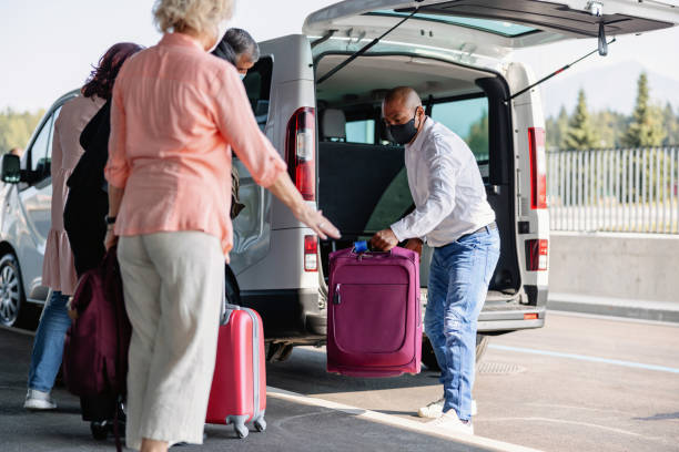 istock Mature Latin-American Van Driver Carrying A Passenger Suitcase 1757621973