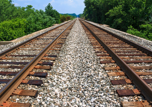 Train arriving at station and one leaving. High angle view.