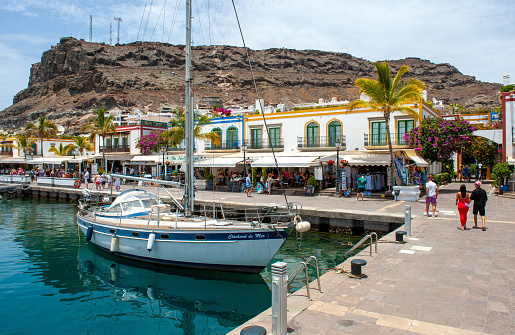 GRAN CANARIA, SPAIN - JUL 31, 2023: Boat in the small harbor of Playa de Mogan on canarynisland Gran Canaria