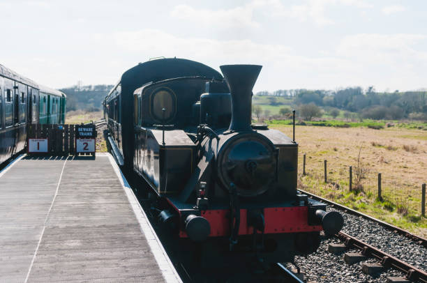 istock Steam train approaches a platform with another train stationary. 1757671685