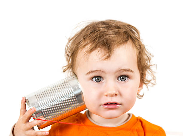 istock child with tin can phone looking to camera 175769983