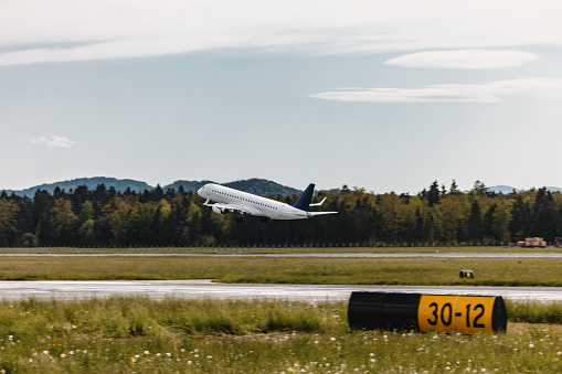 Commercial airplane taking off from an airports runway.