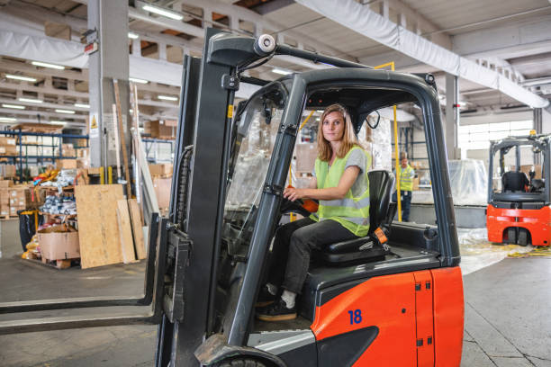 istock Caucasian Female Driving A Forklift At The Airport Warehouse 1757719476