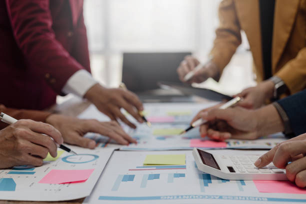 istock Businessman or accounting team analyzing graph data chart and laptop dashboard to prepare statistical reports and discuss financial data to analyze market data. Close-up image 1757728197