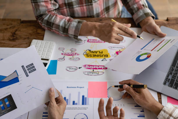istock Businessman or accounting team analyzing graph data chart and laptop dashboard to prepare statistical reports and discuss financial data to analyze market data. Close-up image 1757728206
