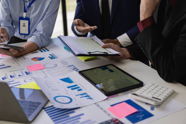 istock Businessman or accounting team analyzing graph data chart and laptop dashboard to prepare statistical reports and discuss financial data to analyze market data. Close-up image 1757728211