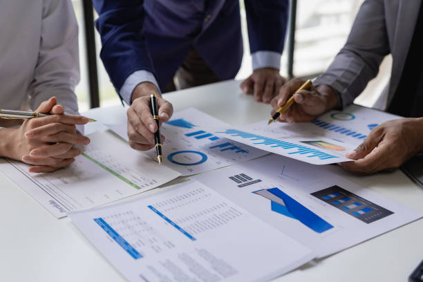 istock Businessman or accounting team analyzing graph data chart and laptop dashboard to prepare statistical reports and discuss financial data to analyze market data. Close-up image 1757728218