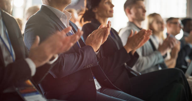 istock Close Up on Hands of Audience Applauding in Concert Hall During Business Forum Presentation. Technology Summit Auditorium Room With Corporate Delegates. Excited Entrepreneurs Clapping. 1757733708