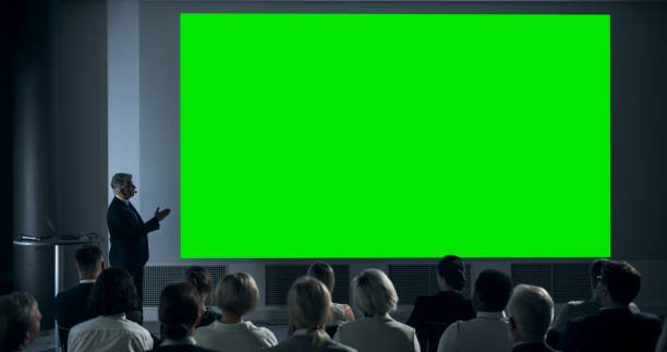 istock Corporate Event: Caucasian Male Tech CEO Giving Presentation On Green Screen Chromakey Projector Display To Colleagues In Conference Room Of Startup Office. Man Talking About Business Objectives. 1757735957