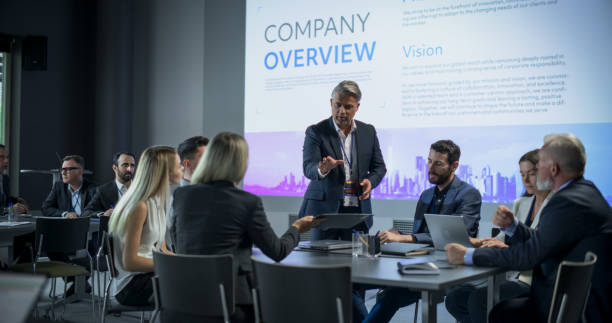 istock Corporate Event: Caucasian Male Tech CEO Hosting Team Building Workshop With Diverse Employees In Conference Room Of Innovative Startup Company Office. Successful People Discussing Business Objectives 1757737600