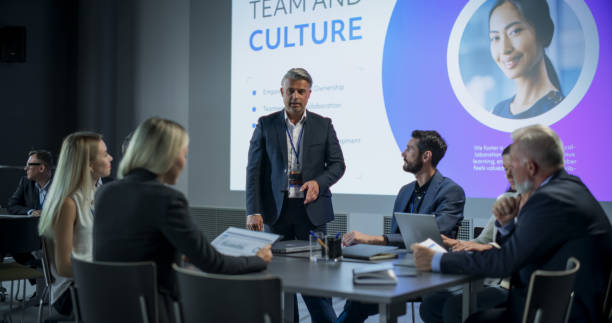 istock Corporate Event: Caucasian Male Tech CEO Hosting Team Building Workshop With Diverse Employees In Conference Room Of Innovative Startup Company Office. Successful People Discussing Business. 1757738122