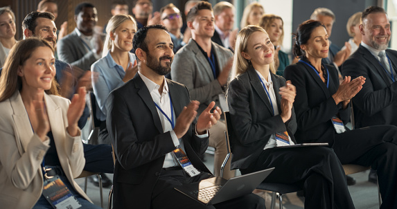 Businessman on a podium giving a speech at a business conference