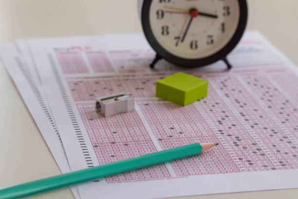 paper answer sheet optical form of standardized test on desk - examen stockfoto's en -beelden