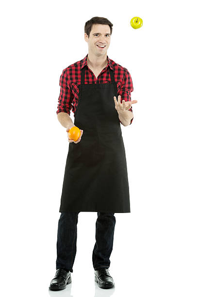 istock Smiling young man with orange and green apple 175775141