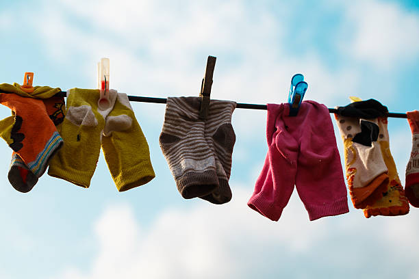 istock Baby socks on clothesline to dry. Blue sky. 175775189