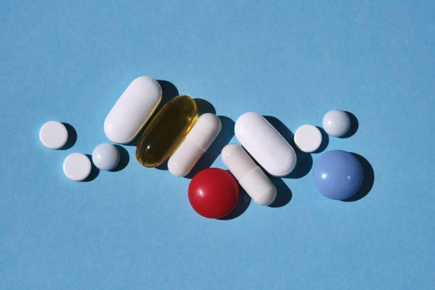 istock Various pills, supplements and vitamins on a blue. 1757752342