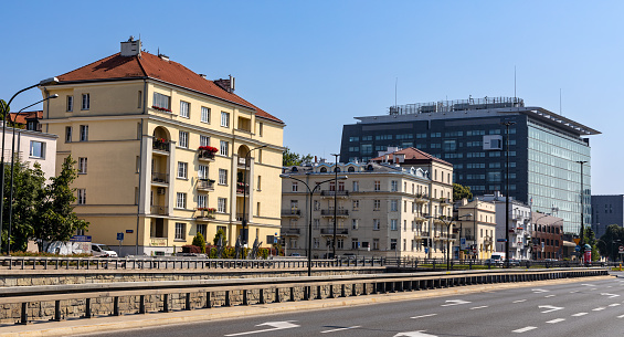 Warsaw, Poland - July 25, 2021: Historic tenement houses and Focus Filtrowa office complex at Wawelska street and Niepodleglosci Avenue junction in Mokotow district of Warsaw