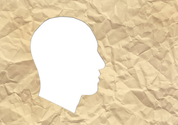istock Human head cut out of crumpled brown paper, in plain white, with copy space 1757764344