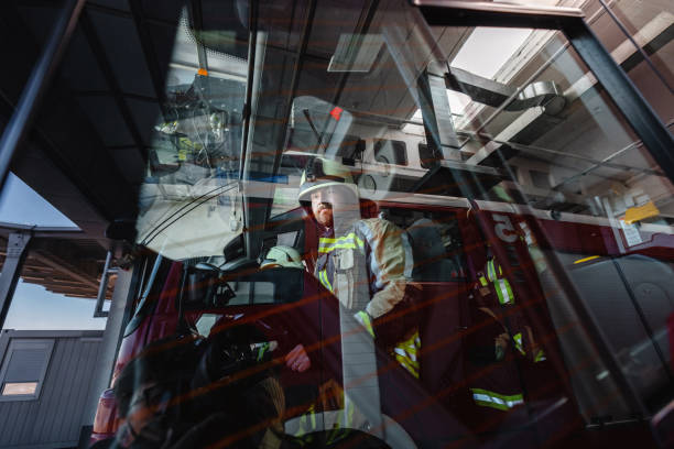 Outdoors shot of a firefighter sitting in the truck.