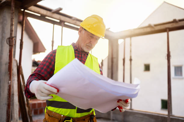 istock Senior Caucasian male architect looking at blueprint, on a construction site 1757787540