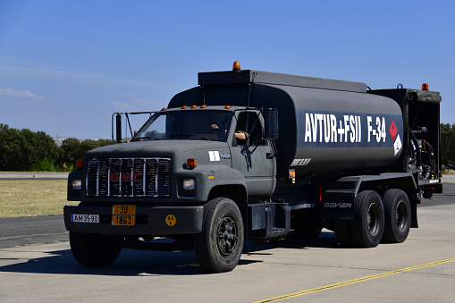 Beja, Portugal: military aviation fuel truck (GMC TopKick), marked AVTUR for Aviation Turbine Fuel, FSII for fuel system icing inhibitor and F-34 for NATO designation of of JP-8 (