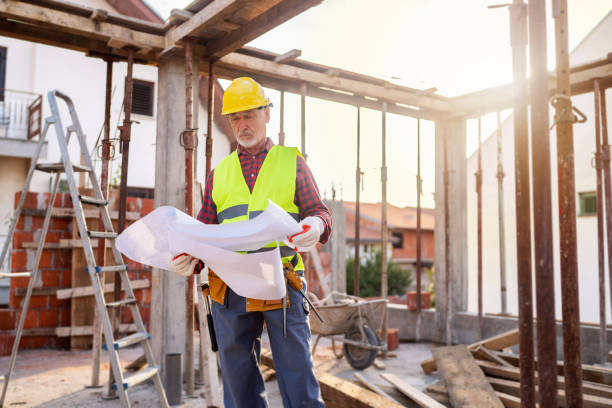 istock Senior Caucasian male architect looking at blueprint, on a construction site 1757793676