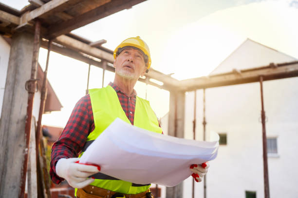 istock Senior Caucasian male architect observing the work in project on a construction site while holding blueprint 1757793677