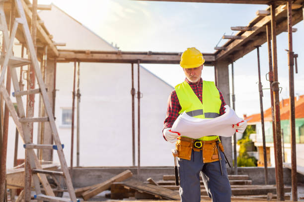 istock Senior Caucasian male architect looking at blueprint, on a construction site 1757793679