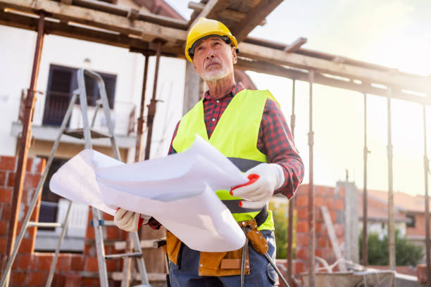 istock Senior Caucasian male architect observing the work in project on a construction site while holding blueprint 1757793681