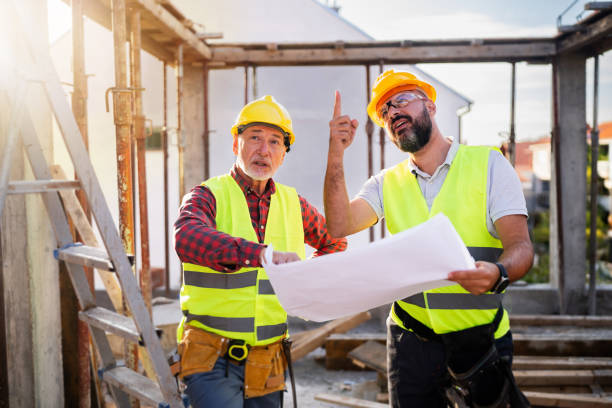 istock Caucasian architect and building contractor having an meeting about project on a construction site 1757796461