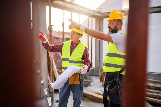 istock Caucasian architect and building contractor having an meeting about project on a construction site 1757800485