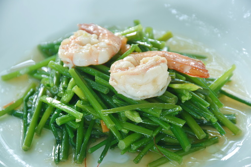 stir fried garlic chives with shrimp in soy sauce on plate