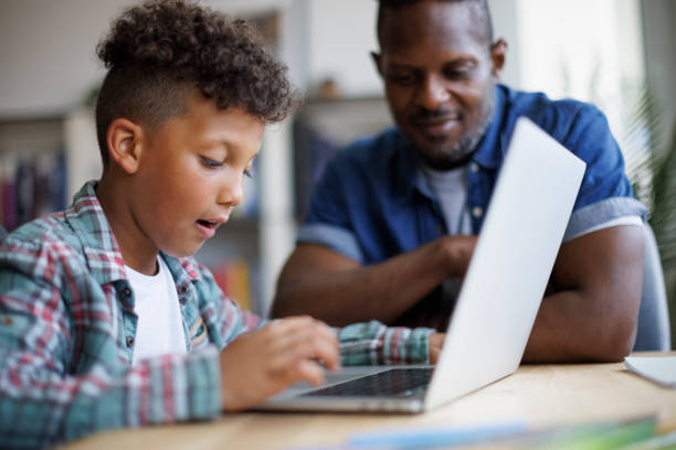 istock Father and son using laptop at home 1757822580