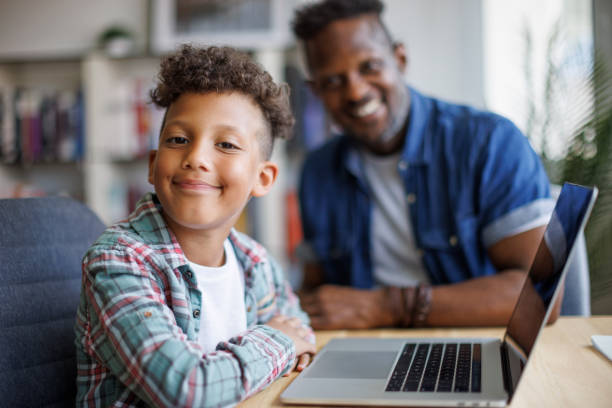 istock Father and son using laptop at home 1757822587