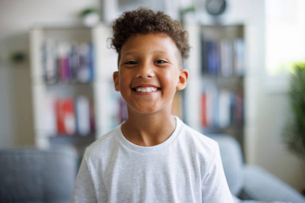 Close up portrait of a cute smiling boy at home stock photo