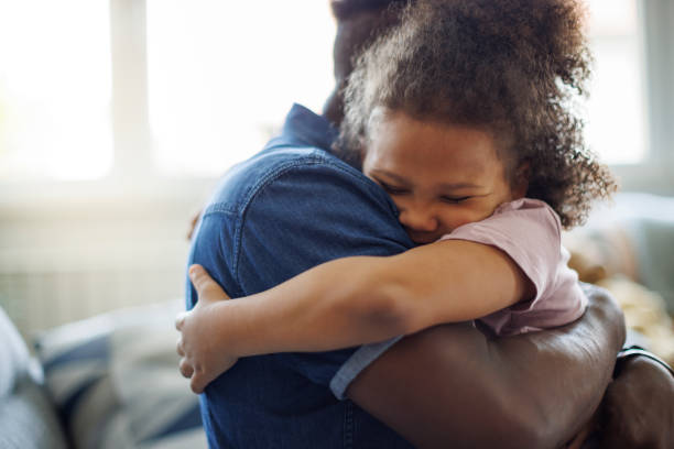 istock Father and daughter embracing at home 1757822592